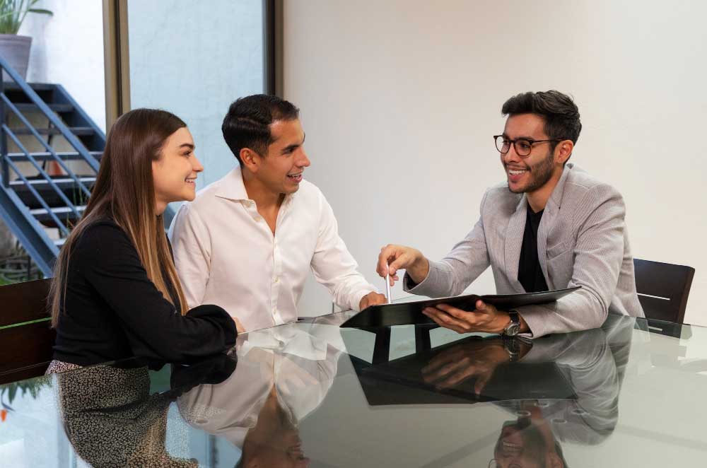 Businesswoman shaking hands with a client in a modern office, symbolizing successful negotiations and trusted financial expertise through M&A Advisory Washington services.